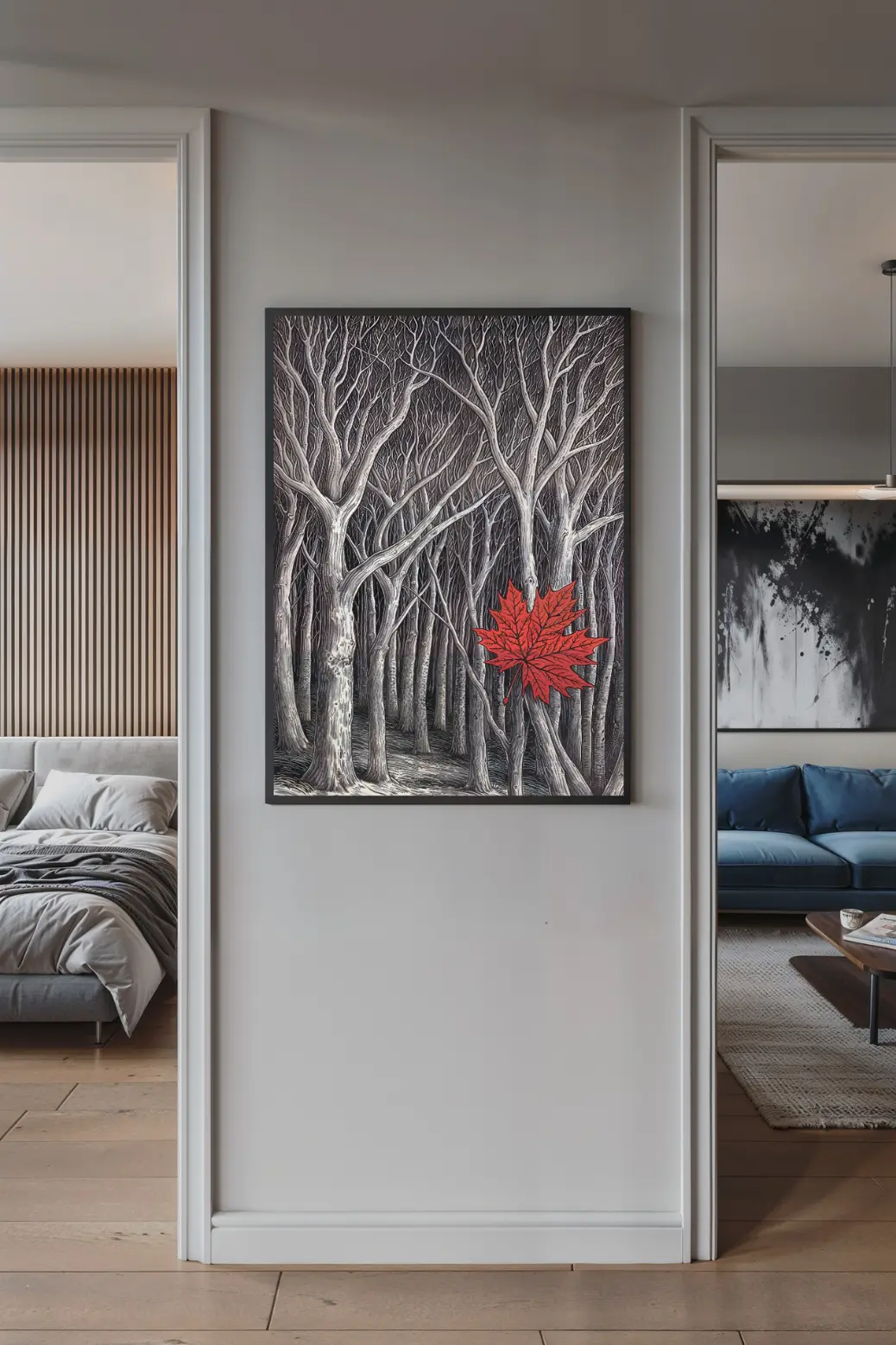 The monochrome forest art print with its single red leaf, framed and placed on a desk in a stylish home office setting.